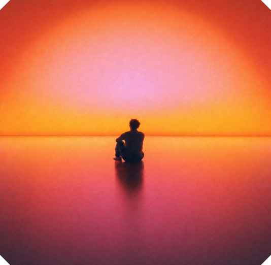 Silhouette of a person sitting on a reflective surface, looking toward a bright, colourful orange and pink horizon.